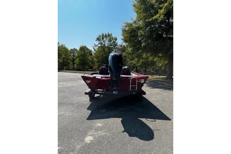 Slide: The Image of 2026 Ranger RT178 boat in a parking lot, rear view with trees in background. - 3