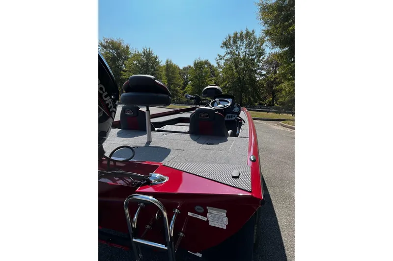 Slide: The Image of 2026 Ranger RT178 boat with red exterior, parked outdoors on a sunny day. - 4