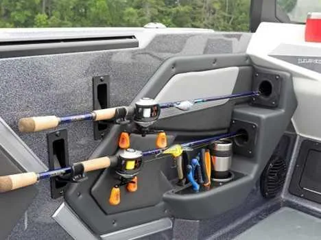 Slide: The Image of 2026 Lund 202 PRO V GL boat interior with fishing rod holders and storage compartments. - 8