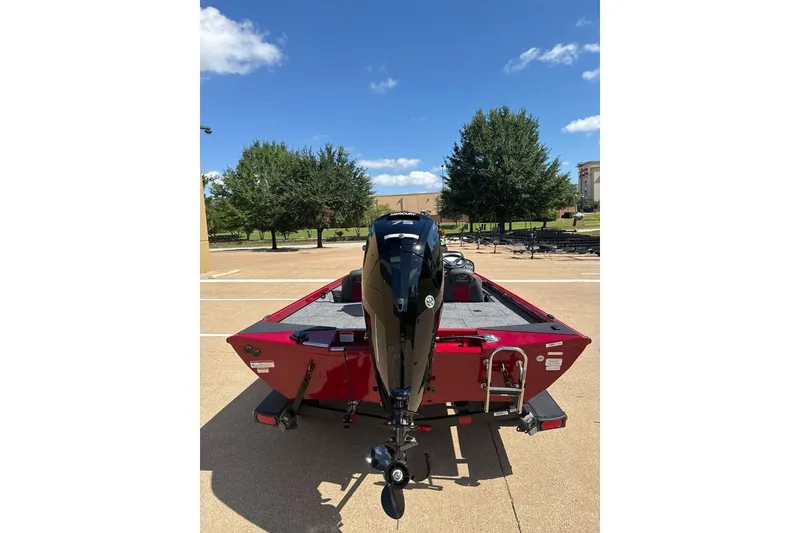 Slide: The Image of 2026 Ranger RT178 boat, red exterior, parked outdoors under a clear blue sky. - 4