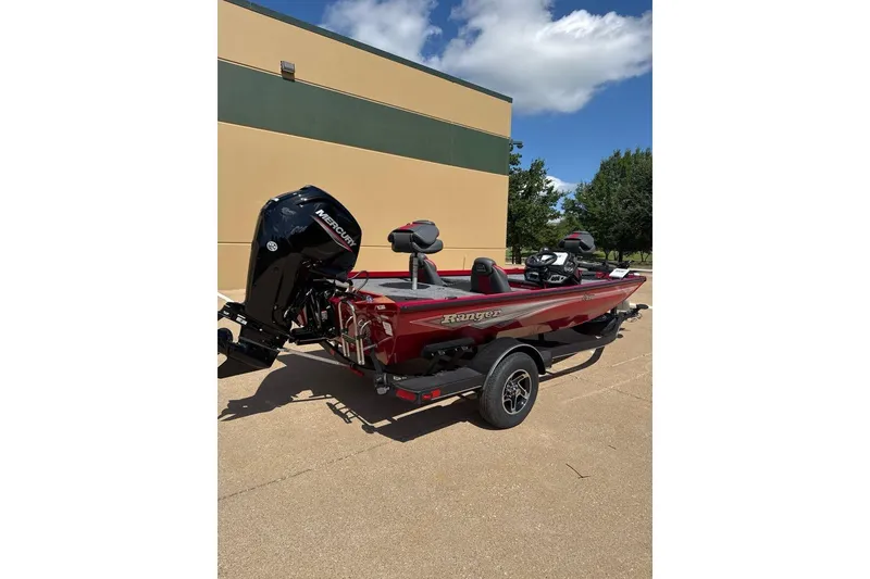 Slide: The Image of 2026 Ranger RT178 boat with Mercury engine, parked outdoors under a clear blue sky. - 5