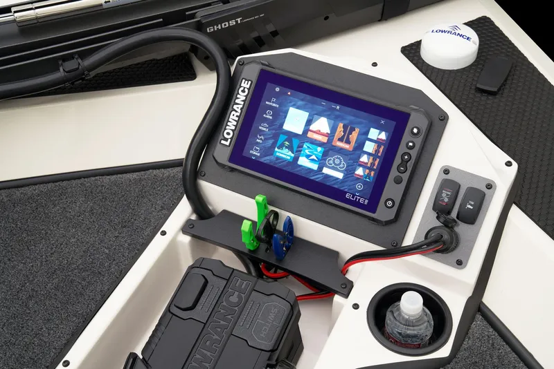 Slide: The Image of 2026 Ranger RT198P boat storage compartment with fishing rod holders and carpeted interior. - 10