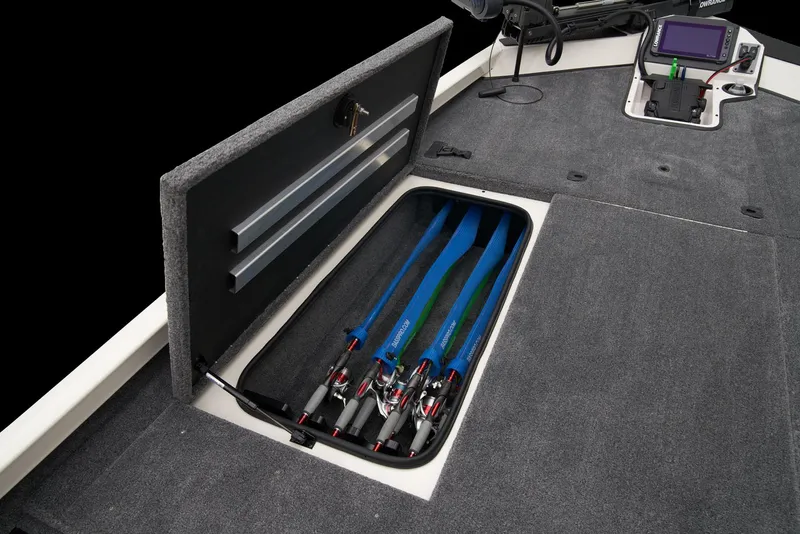 Slide: The Image of Open storage compartment in 2026 Ranger RT198P boat, featuring carpeted interior and secure latch. - 12