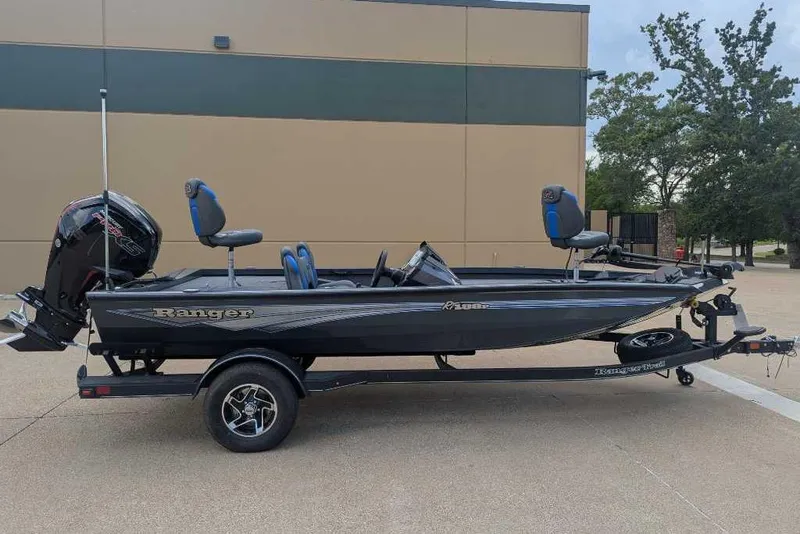 The Image of 2026 Ranger RT188P fishing boat on trailer, parked outdoors. - 1