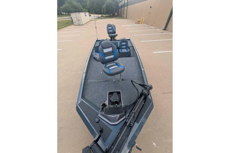 Slide: The Image of 2026 Ranger RT188P fishing boat with blue seats in a parking lot. - 6