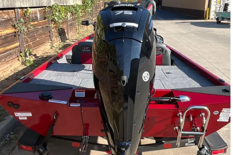Slide: The Image of 2026 Ranger RT178 boat with Mercury 75 engine, red exterior, parked outdoors. - 2
