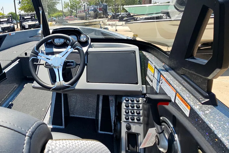 Slide: The Image of Interior view of a 2026 Ranger 1850MS boat dashboard with steering wheel and controls. - 9