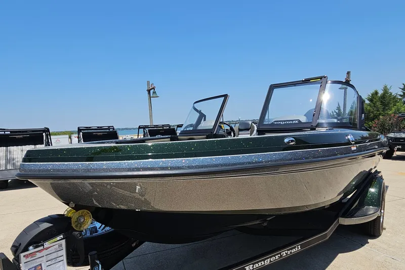 Slide: The Image of 2026 Ranger 1850MS boat on trailer, sparkling finish, clear sky background. - 1