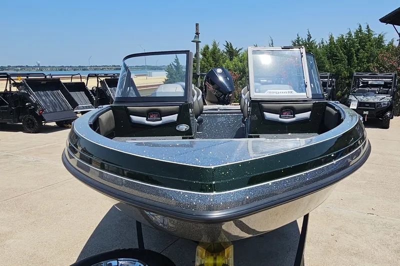 Slide: The Image of 2026 Ranger 1850MS boat displayed outdoors, featuring sleek design and modern features. - 2