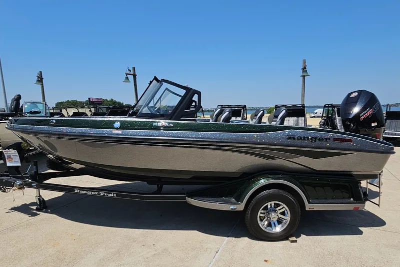 The Image of 2026 Ranger 1850MS boat on trailer, sleek design, parked outdoors under clear sky. - 0