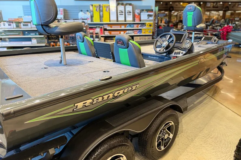 Slide: The Image of 2026 Ranger RT198P fishing boat with green accents, displayed indoors. - 2