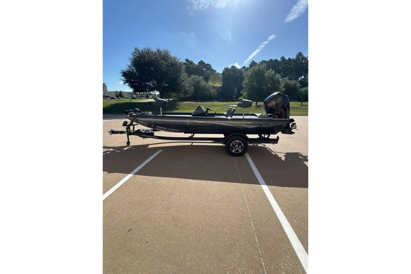 The Image of 2026 Ranger RT188C boat on trailer in sunny parking lot. - 0