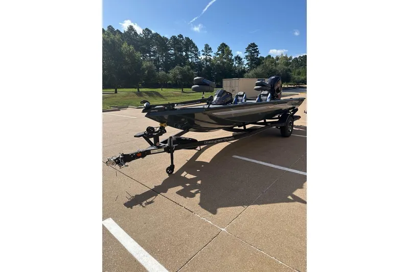 Slide: The Image of 2026 Ranger RT188C fishing boat on trailer in sunny parking lot. - 2