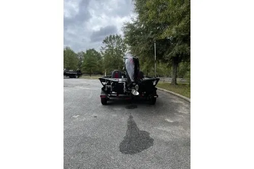 Slide: The Image of 2026 Ranger RT188P boat on a trailer in a wooded parking area. - 3