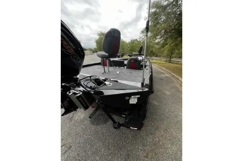 Slide: The Image of 2026 Ranger RT188P fishing boat, sleek design, parked on a road with trees in the background. - 4