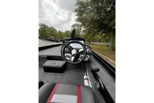 Slide: The Image of 2026 Ranger RT188P boat interior with steering wheel and dashboard, parked outdoors. - 5