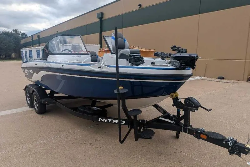 Slide: The Image of 2026 Nitro ZV19 Sport Pro boat on trailer, parked outdoors. - 5