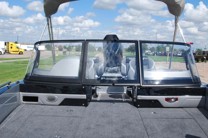 Slide: The Image of 2026 Ranger 621FS Cup Equipped boat with windshield and seating, parked outdoors. - 16