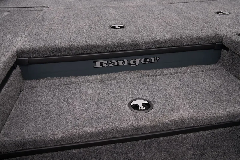 Slide: The Image of 2026 Ranger RT178 boat interior with carpeted deck and storage compartments. - 23