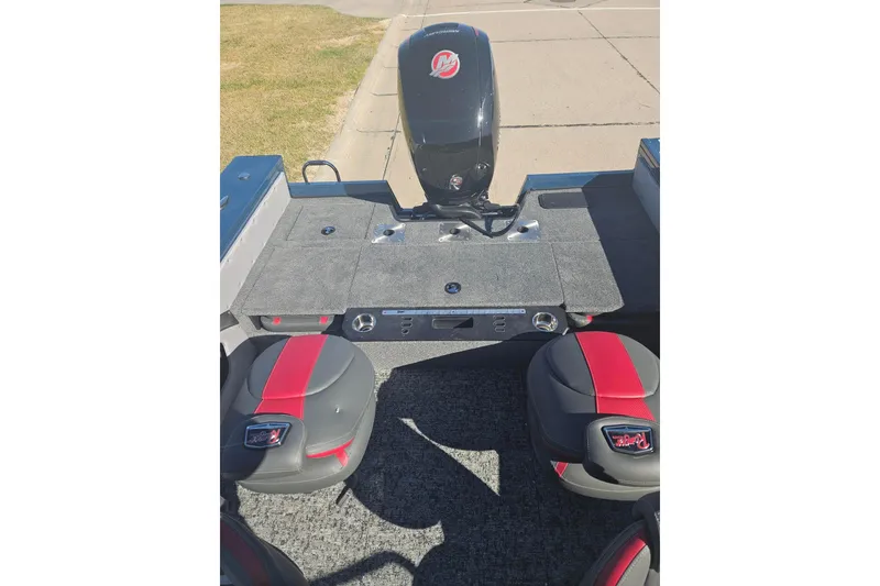 Slide: The Image of 2026 Ranger VX1788 WT boat interior with red and gray seating and motor. - 11