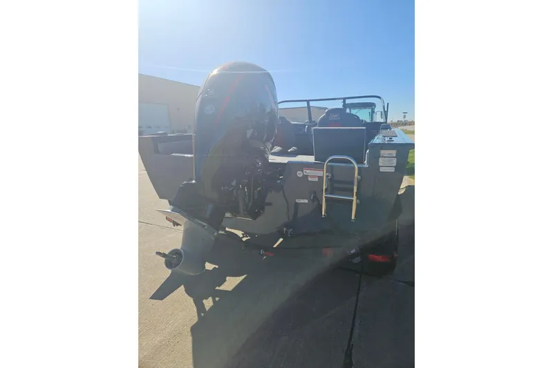 Slide: The Image of 2026 Ranger VX1788 WT boat with outboard motor and ladder, parked outdoors. - 4