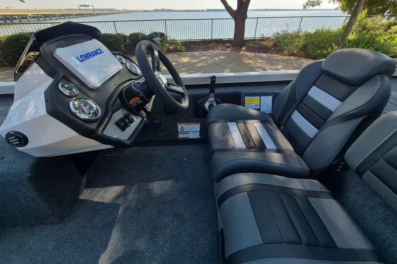 Slide: The Image of 2026 Ranger RT188C boat interior with steering wheel, gauges, and comfortable seating. - 12