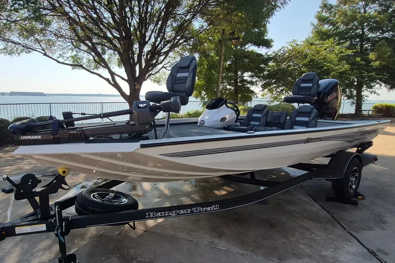 Slide: The Image of 2026 Ranger RT188C fishing boat on trailer by lakeside, featuring modern design and equipment. - 1