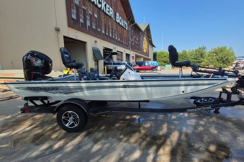 Slide: The Image of 2026 Ranger RT188C fishing boat on trailer outside Tracker Boats store. - 5