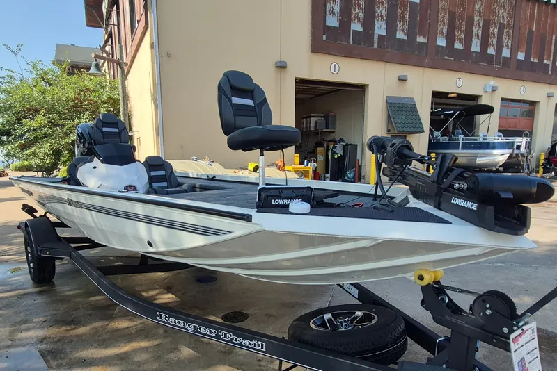 Slide: The Image of 2026 Ranger RT188C fishing boat on trailer, equipped with Lowrance electronics, parked outside a building. - 4