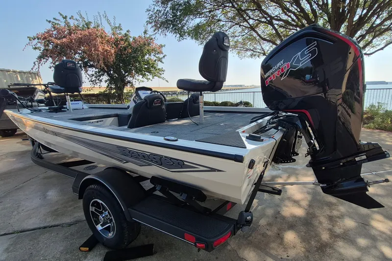 Slide: The Image of 2026 Ranger RT188C fishing boat with Mercury Pro XS engine, parked near a waterfront. - 8