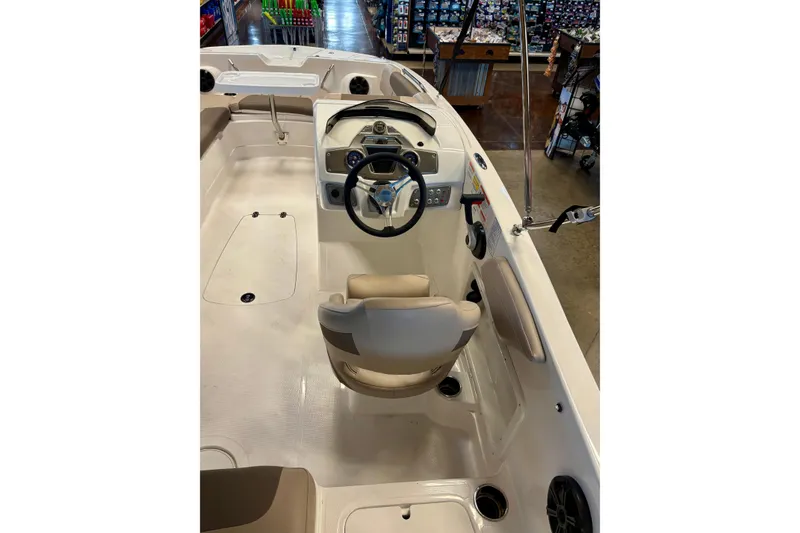 Slide: The Image of 2026 Tahoe 2150 boat interior with steering wheel and seating, showcasing modern design. - 97