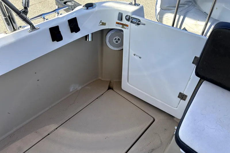 Slide: The Image of 2013 Ranger Tugs R-27 boat interior with seating and storage compartment. - 10