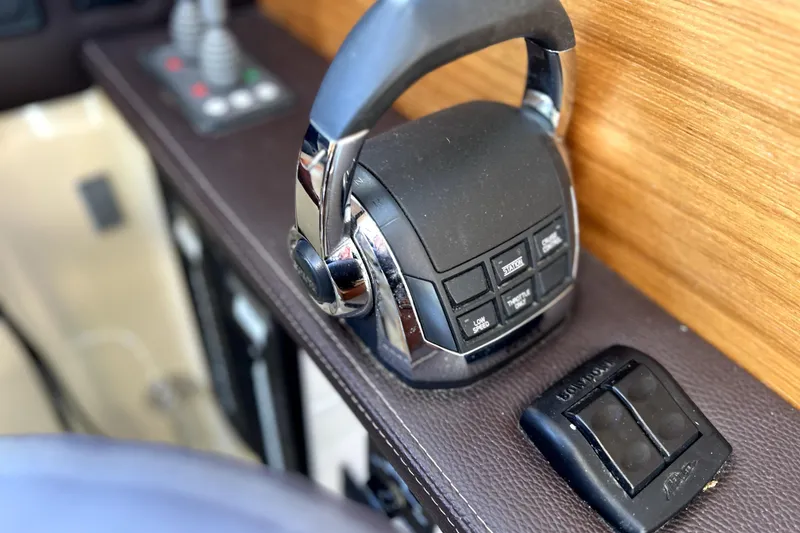 Slide: The Image of Close-up of 2013 Ranger Tugs R-27 boat throttle controls on a wooden panel. - 23