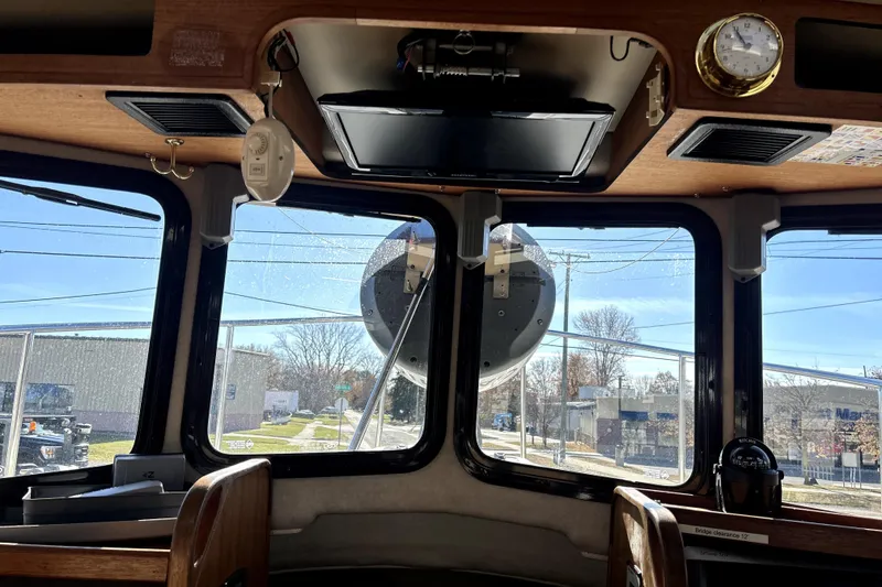 Slide: The Image of Interior view of 2013 Ranger Tugs R-27 boat cockpit with windows and navigation equipment. - 27