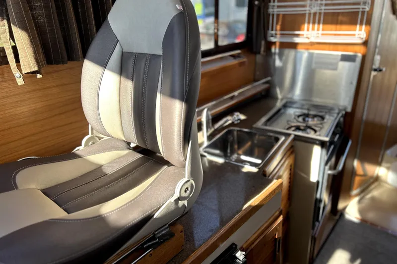 Slide: The Image of Interior of 2013 Ranger Tugs R-27 with seating, sink, and stove in compact kitchen area. - 28