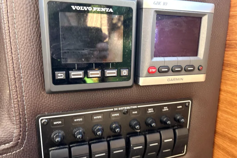 Slide: The Image of Control panel of a 2013 Ranger Tugs R-27 with Volvo Penta and Garmin displays. - 32