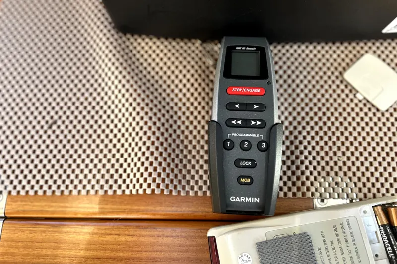 Slide: The Image of Garmin remote control on a 2013 Ranger Tugs R-27 boat, placed on a textured surface. - 34