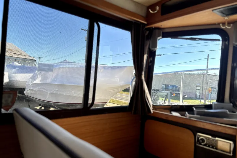 Slide: The Image of Interior view from a 2013 Ranger Tugs R-27, overlooking wrapped boats outside. - 38