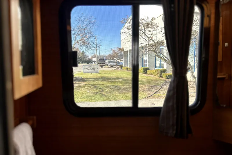 Slide: The Image of View from inside a 2013 Ranger Tugs R-27, looking out a window at a marina. - 40