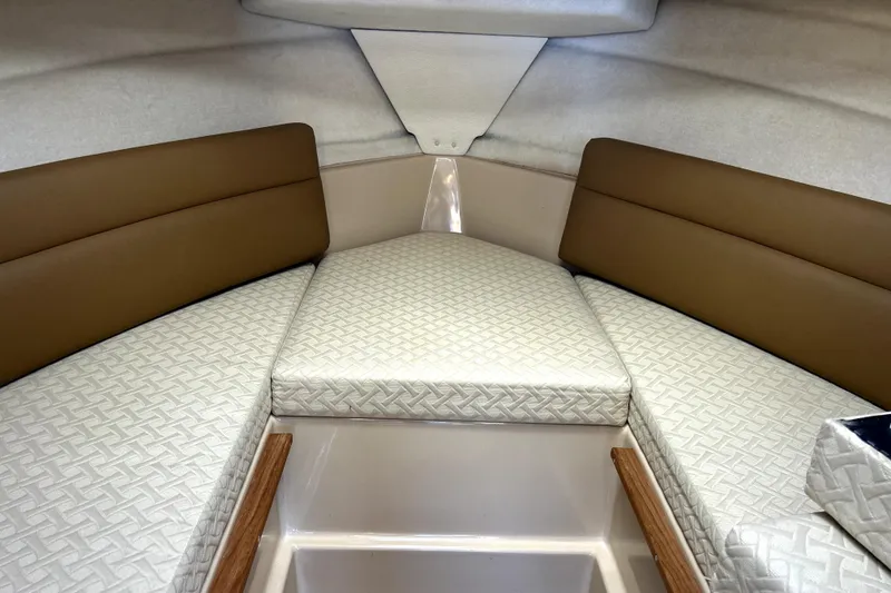 Slide: The Image of 2013 Ranger Tugs R-27 cabin interior with cushioned seating and patterned upholstery. - 46