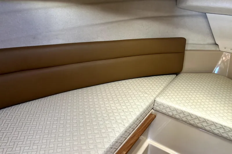 Slide: The Image of 2013 Ranger Tugs R-27 interior with cushioned seating and patterned upholstery. - 47