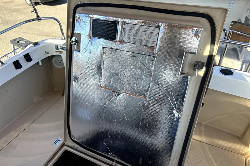 Slide: The Image of 2013 Ranger Tugs R-27 boat hatch with insulation and safety instructions. - 54