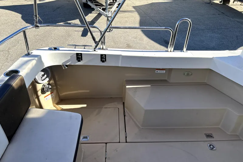 Slide: The Image of 2013 Ranger Tugs R-27 boat interior with seating and storage compartments. - 8