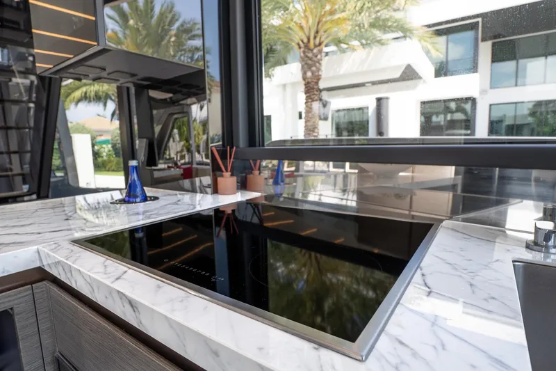 Slide: The Image of Modern kitchen with marble countertop and sleek induction cooktop on Explorer EX62, 2024 model. - 13
