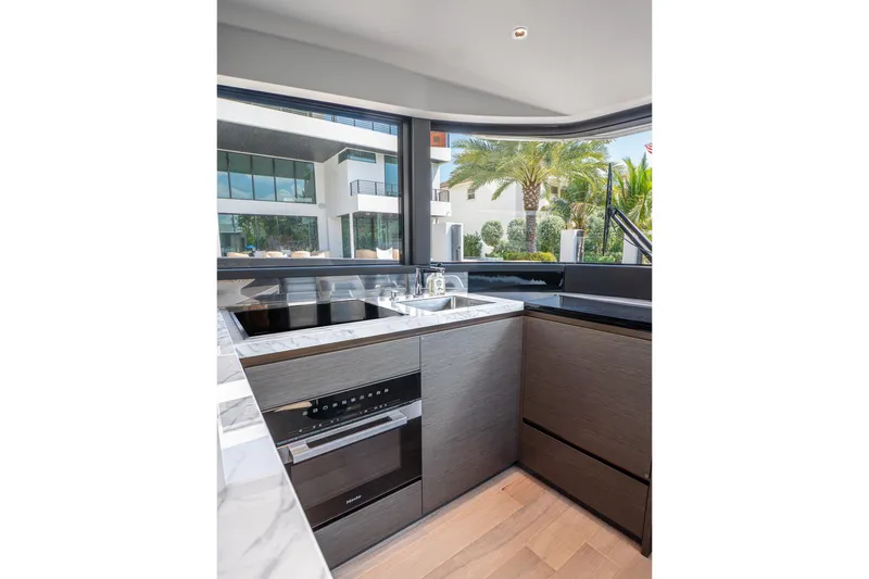 Slide: The Image of Modern kitchen interior on 2024 Explorer EX62 yacht with sleek design and large windows. - 14