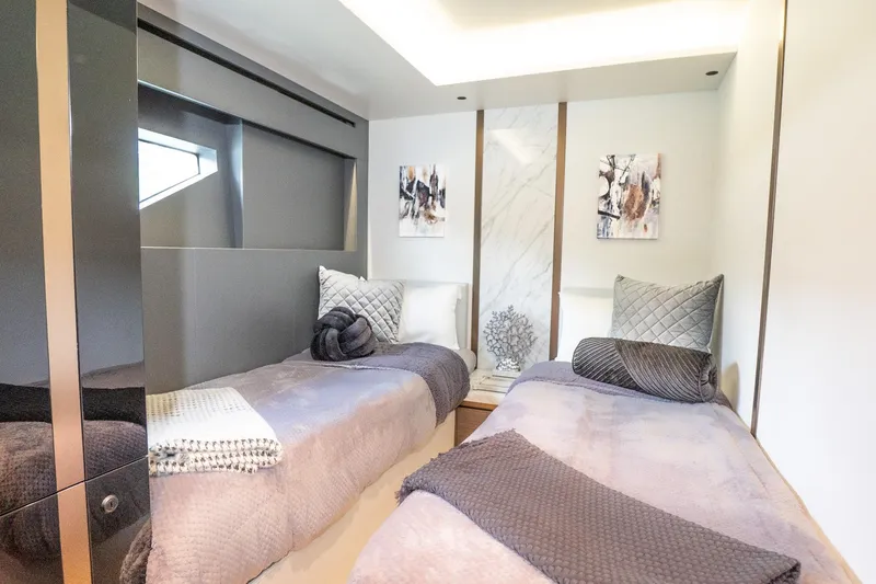 Slide: The Image of Luxurious 2024 Explorer EX62 yacht cabin with twin beds and elegant decor. - 20