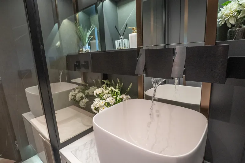 Slide: The Image of Modern bathroom with sleek sink, flowing water, and elegant decor, featuring Explorer EX62, 2024. - 22