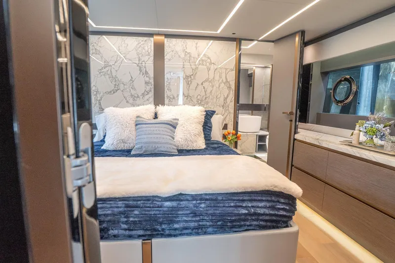 Slide: The Image of Luxurious 2024 Explorer EX62 yacht bedroom with plush bedding and elegant marble accents. - 28