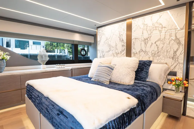 Slide: The Image of Luxurious 2024 Explorer EX62 yacht bedroom with marble accents and plush bedding. - 30