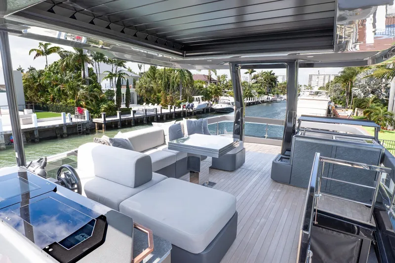 Slide: The Image of Luxurious 2024 Explorer EX62 yacht deck with modern seating and scenic waterfront view. - 36